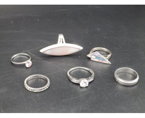 6 silver rings - a large marquise shaped pink pearlised stone, an art deco style ring, two bands, a pink stone and a cubic zi