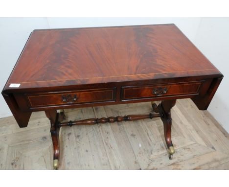 Mahogany reproduction drop-leaf sofa table with two drawers and turned under stretcher 