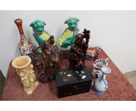 Two Eastern carved hardwood figures, a lacquered tea caddy, a pair of Dogs of Foe and a selection of other Oriental decorativ