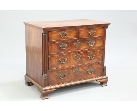 A GEORGE III RED WALNUT CHEST OF DRAWERS, the rectangular top above two short over three long graduated drawers, each with pi