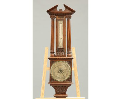 A VICTORIAN MAHOGANY BAROMETER, the silvered 20cm dial within a floral carved case and above a thermometer between fluted col