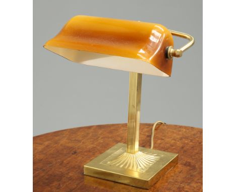 A GEORGIAN STYLE BRASS DESK LAMP, with adjustable glass shade. 35cm high