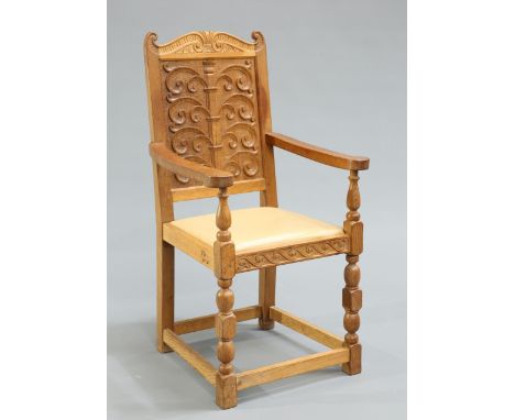 DON CRAVENA FOXMAN OAK HALL CHAIR, with scroll carved panel back and seat rail, raised on block and baluster legs joined by a