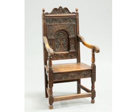 A 17TH CENTURY STYLE CARVED OAK JOINED CHAIR, 19TH CENTURY, with scroll and foliate carved crest rail above lunettes, flowerh