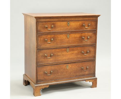 A GEORGE III OAK CHEST OF DRAWERS, fitted with four long graduated drawers, each with brass swan neck handles and pierced bra