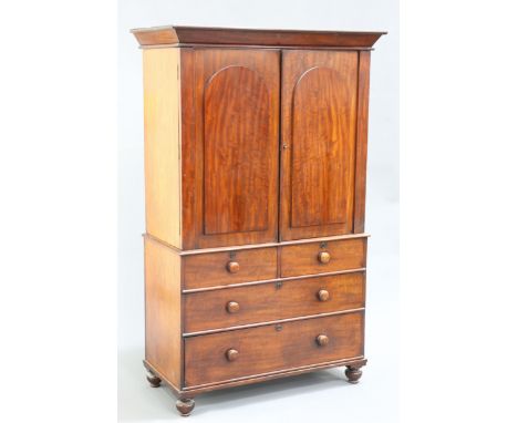 A MAHOGANY PRESS CUPBOARD, FIRST QUARTER OF 19TH CENTURY,&nbsp;the upper section with a pair of arched panel doors opening to