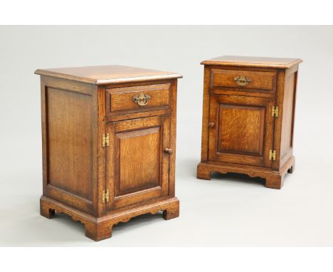 A PAIR OF PERIOD STYLE OAK BEDSIDE CABINETS BY TITCHMARSH AND GOODWIN, each fitted with a drawer over a panel door with brass