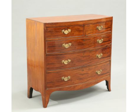 AN EARLY 19TH CENTURY MAHOGANY BOW-FRONT CHEST OF DRAWERS, with two short over three long graduated drawers, each fitted with