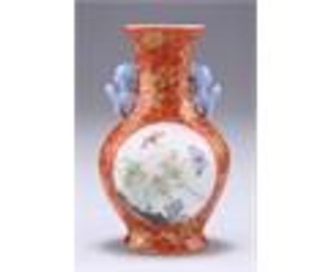 A SMALL CHINESE PORCELAIN VASE, gilt decorated with prunus and cracked ice on an iron red ground, painted to each side with b