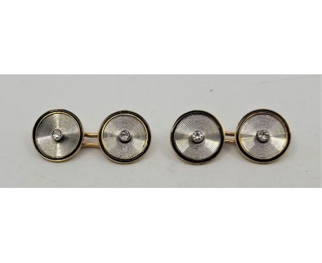 A pair of French 18ct. gold, black enamel and diamond circular cufflinks, each face bezel set round cut diamond to centre wit