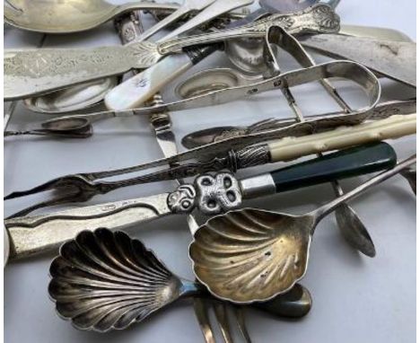 A collection of silver and silver plated flatware, to include; a jade handled silver knife, George III bright cut sugar tongs