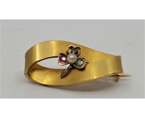 A18ct. gold, peridot, ruby, diamond and pearl brooch, fashioned with Shamrock set rose cut diamond, old cut peridot and old c