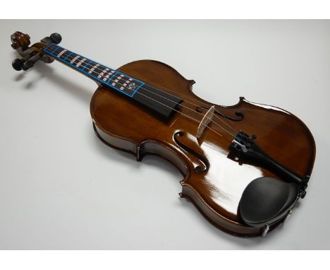 A Forenza students violin, having ebony fingerboard and two-piece back, bearing a label for Forenza Model F2151A/4 Violin, in