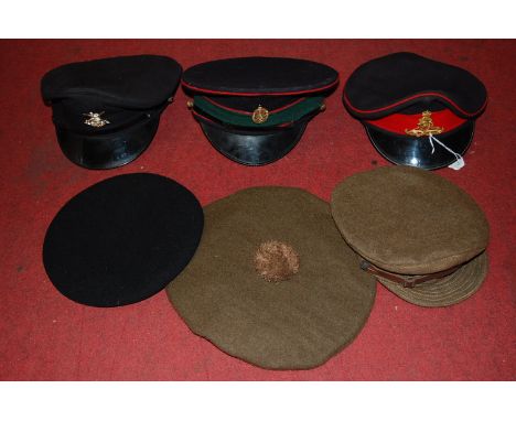 A British beret in blue with War Department arrow, dated 1944; together with a Scottish Tam o'Shanter; a Royal Artillery peak