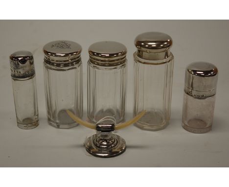 Assorted silver topped glass dressing table bottles (5), together with a silver and mother of pearl ring stand modelled as a 