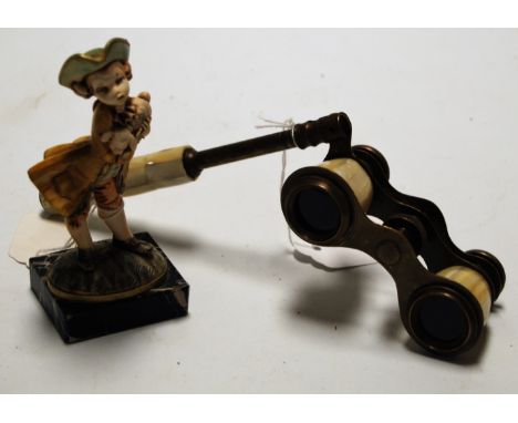 A pair of early 20th century mother of pearl opera glasses together with continental figure of a child holding a lamb (2)
