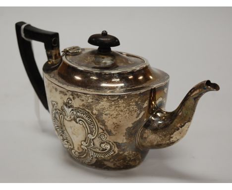 A late Victorian silver and embossed teapot of oval form with ebony handle, gross weight 11.5oz, Birmingham 1894, height 12cm