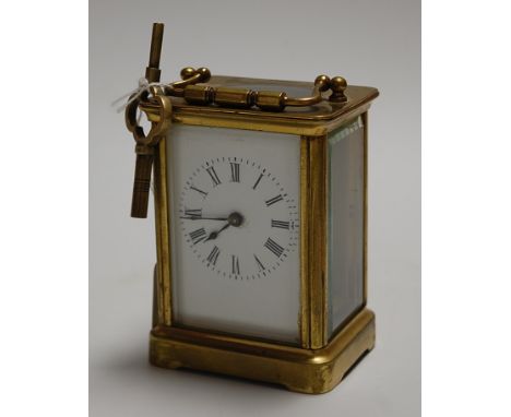 A mid-20th century lacquered brass cased carriage clock, having an enamelled dial with Roman numerals and visible platform le