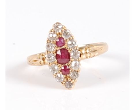 An 18ct gold, ruby and diamond dress ring, the elliptical setting as three central round cut rubies within a surround of twel