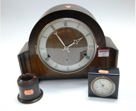 A 1950s oak cased mantel clock, having a silvered chapter ring with Arabic numerals and chiming movement; together with a sma