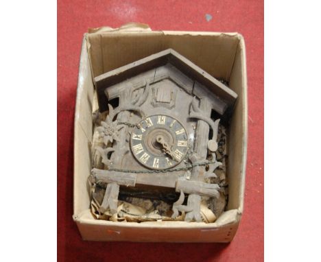 An early 20th century continental carved softwood cased cuckoo clock