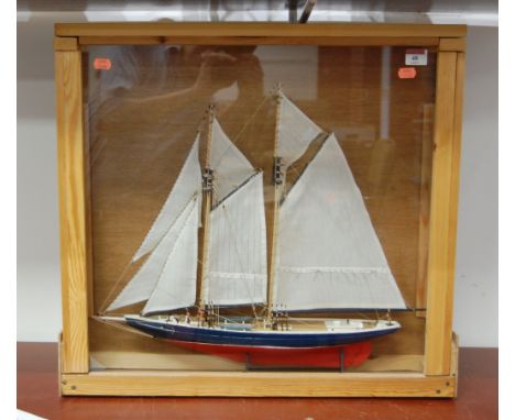 A scratch-built model of a yacht, having full masts and rigging, housed in a glazed pine display case, case dimensions 56 x 5