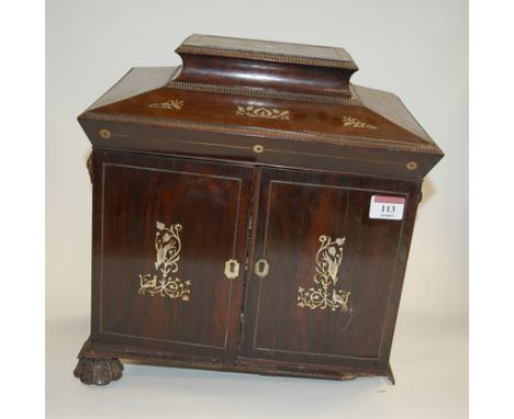 A circa 1830 rosewood and mother of pearl inlaid workbox of sarcophagus form, the hinged lid revealing a fitted interior with