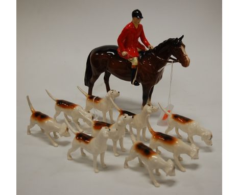 A Beswick hunting set comprising bay hunter with huntsman up, and nine fox hounds, all gloss finish (10). Chip to tip of tail