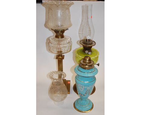 A Victorian oil lamp having a frilled glass shade above a clear glass font on a brass column and stepped square base, togethe