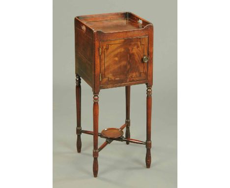 A George III mahogany bedside cabinet, with tray type top, ebony strung door and raised on turned legs united by a low circul