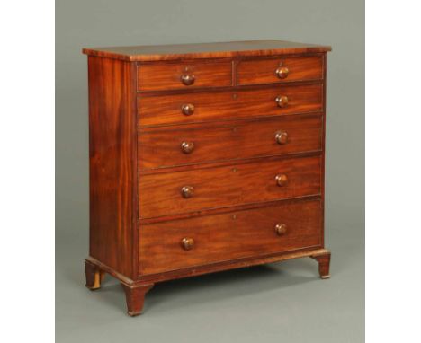 A Victorian mahogany chest of drawers, with moulded edge above two short and four long graduated drawers with wooden knob han