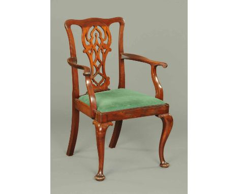 An Edwardian mahogany armchair, in the Chippendale style, and raised on cabriole front legs terminating in pad feet.  