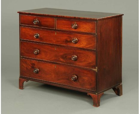 An early 19th century mahogany chest of drawers, two short and three long graduated drawers with wooden knob handles, cockbea