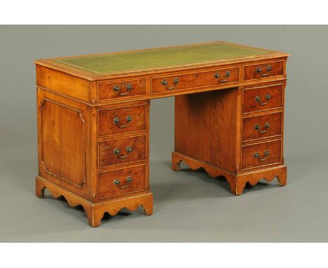 A maple and walnut veneered kneehole desk, with green tooled leather writing surface and fitted with three frieze drawers and
