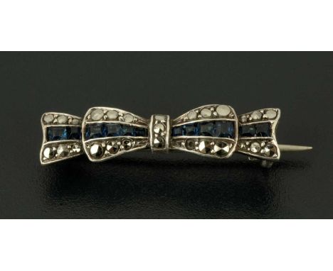 An Edwardian marcasite and sapphire bow brooch.  Length 32 mm. 