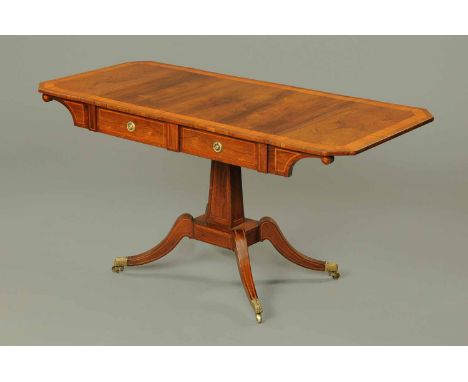 A Regency rosewood and satinwood crossbanded sofa table, each flap with canted angles, fitted with two frieze drawers and rai