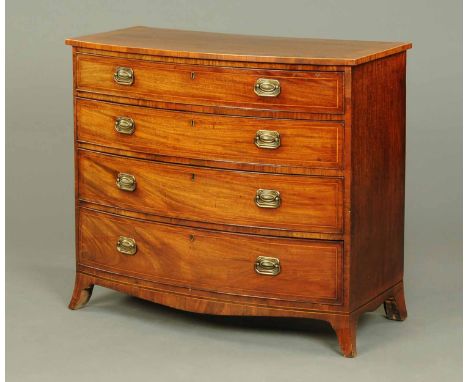An early 19th century mahogany bowfronted chest of drawers, crossbanded and boxwood strung, each drawer fitted with brass dro