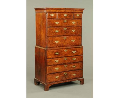 A George I walnut veneered secretaire chest on chest, with moulded cornice and crossbanded frieze above three short and three