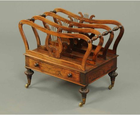 A Regency/William IV rosewood Canterbury, three divisions, with turned supports between, with frieze drawer and raised on tur