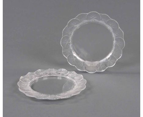 Two Lalique plates, script signature "Lalique, France", each with repeating lily leaf border.  Diameter 27 cm.   CONDITION RE