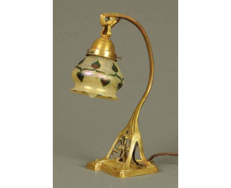 An Art Nouveau table lamp, brass, with Loetz style glass shade.  Height 14 ins (see illustration). 