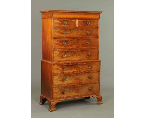 A George III mahogany chest on chest, with dentil cornice above a satinwood inlaid frieze, the upper stage having two short a