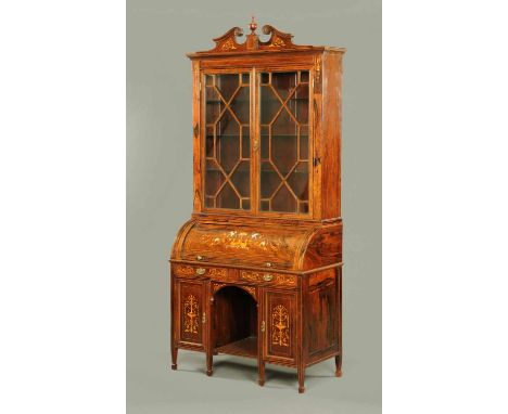 A late Victorian inlaid rosewood cylinder bureau bookcase, with swans neck pediment above a moulded cornice and pair of glaze