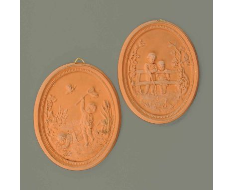 A pair of terracotta plaques, oval, children playing.  Height 7 ins. 