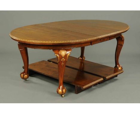 A walnut Queen Anne style extending dining table, with three leaves, carved edge, recessed frieze and raised on cabriole legs