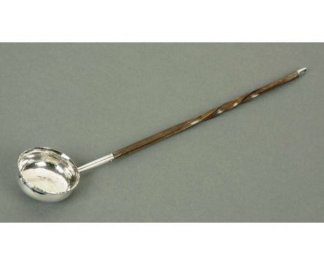 A George III silver coloured toddy ladle, with wrythen bone handle.  Length 36 cm.  