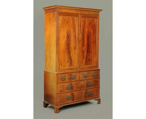 A 19th century mahogany gentleman's press, with detachable moulded cornice above a pair of panelled doors, the base fitted wi