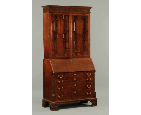 A George III Chippendale period mahogany bureau bookcase, having a moulded dentil cornice above a blind fretwork frieze and p