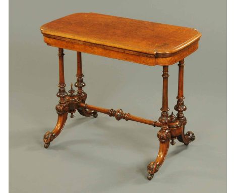 A Victorian walnut turnover top card table, rectangular, with marquetry corners, turned supports, centre stretcher and downsw