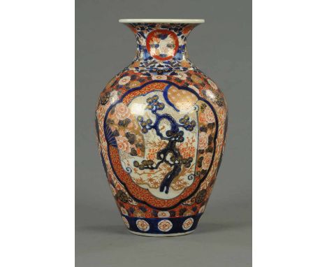 A 19th century Imari vase, intricately decorated in typical Imari colours.  Height 15 ins (see illustration).  CONDITION REPO